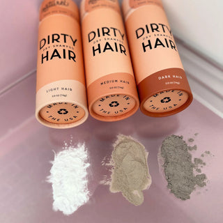 Light, medium and dark dry shampoo powders beside their tubes